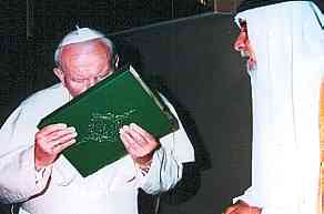  Pope John Paul II Kisses the Koran while meeting with an official in Iraq on May 14, 1999